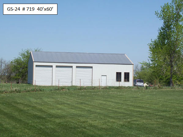 A metal equipment shed with a white exterior and gray roof.