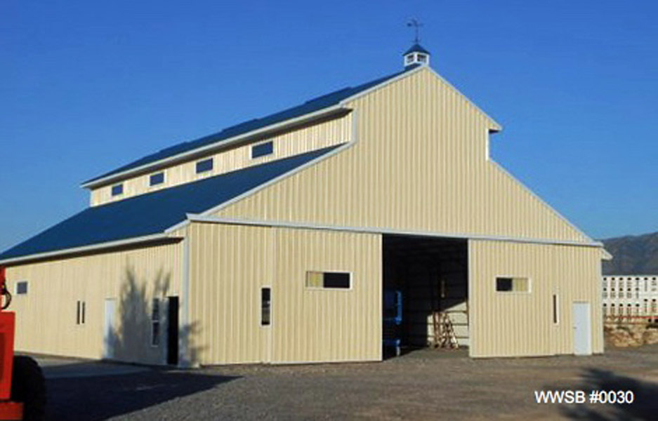 A metal farm building with a cream colored exterior