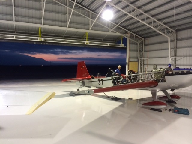 An airplane inside of a steel airplane hangar built by Worldwide Steel Buildings.