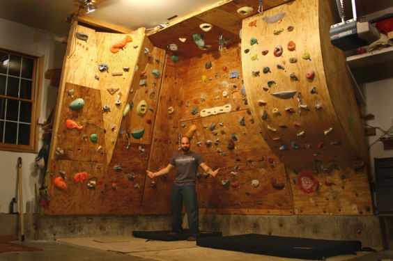 An indoor rock climbing wall inside of a man cave