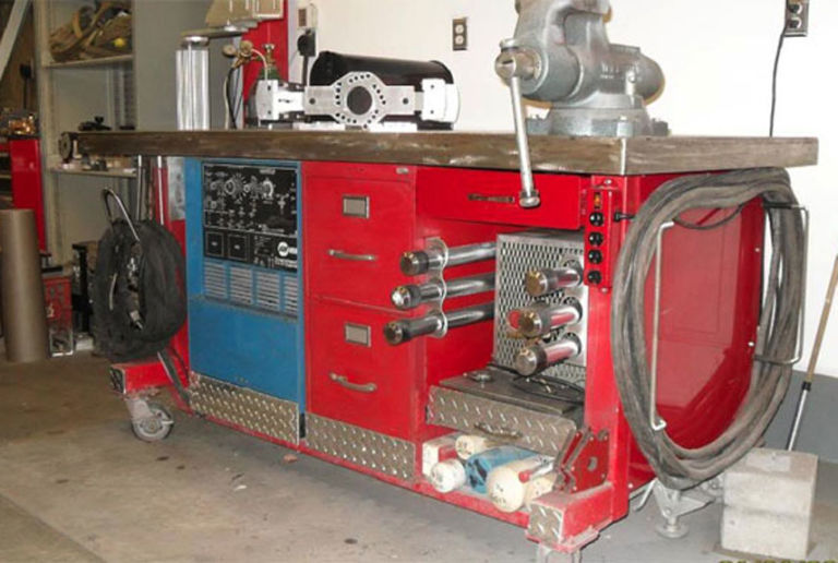 A red welding station built inside of a man cave
