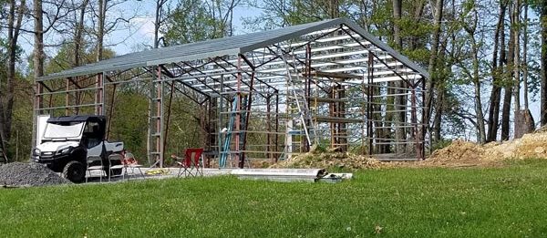 The steel structure with a roof built of a new outdoor garage built by Worldwide Steel Buildings.
