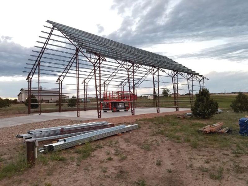 A metal building wedding venue being built with the metal frame in built so far