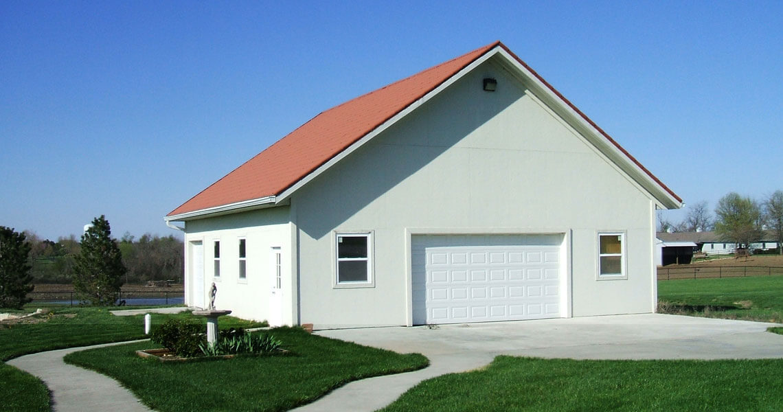 Metal garage kit covered in stucco from Worldwide Steel Buildings.