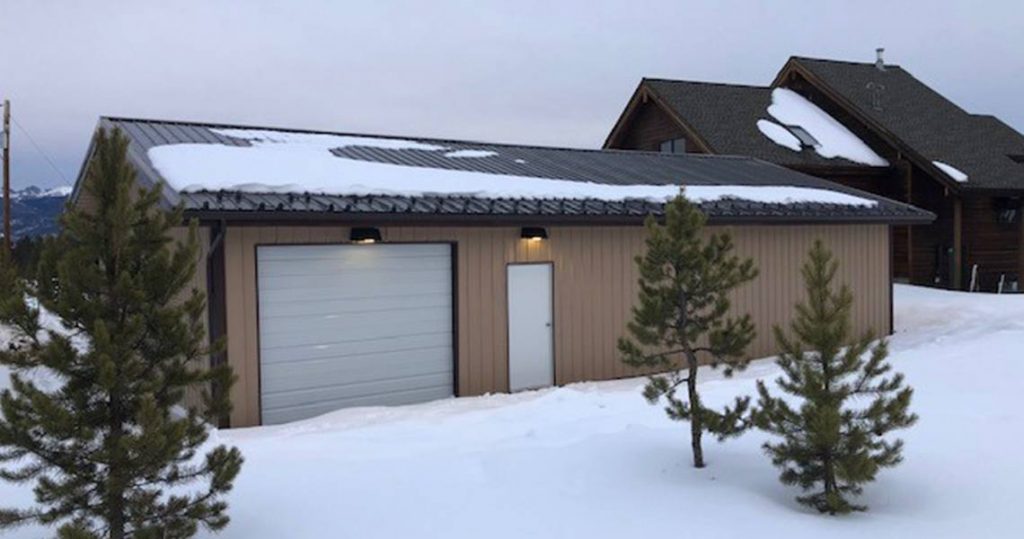 Steel garage building in the snow in winter