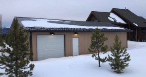 Steel garage building kit from Worldwide Steel Buildings in the snow in winter.