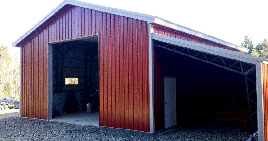 A red building with a metal half truss roof that was built by Worldwide Steel Buildings.
