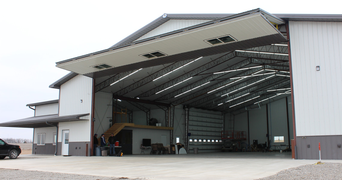 Custom steel storage building with a large door built with a Worldwide Steel Buildings metal kit.