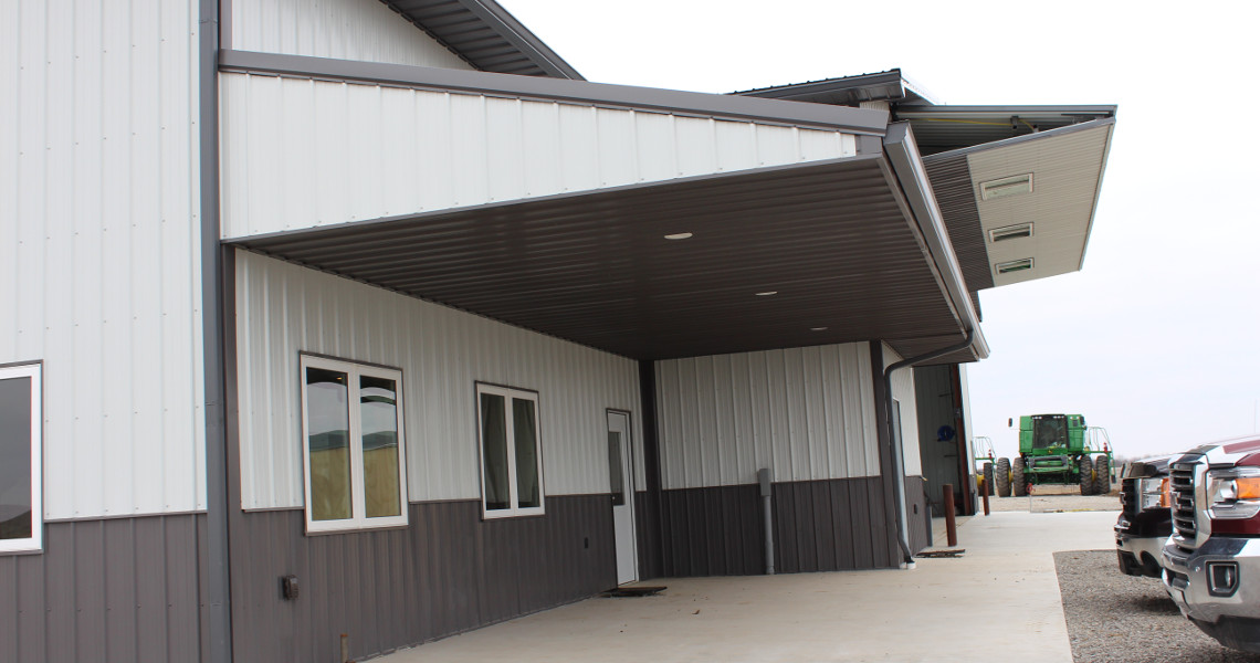 Office space and an overhang added on to the custom steel agricultural shop in Perry, KS, from Worldwide Steel Buildings