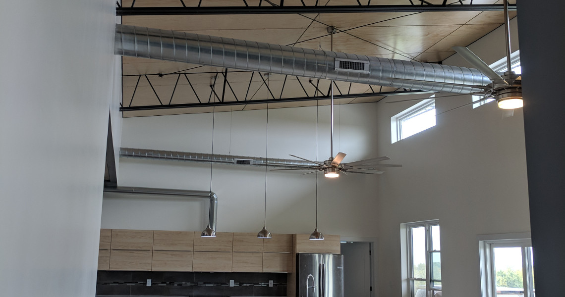 The ceiling fixtures inside of a metal barndominium designed and built by Worldwide Steel Buildings.