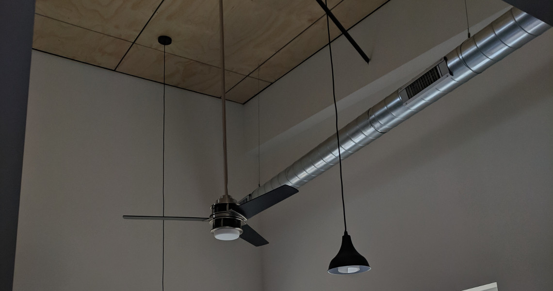 Hanging light fixtures inside of a metal barndominium designed and built by Worldwide Steel Buildings.
