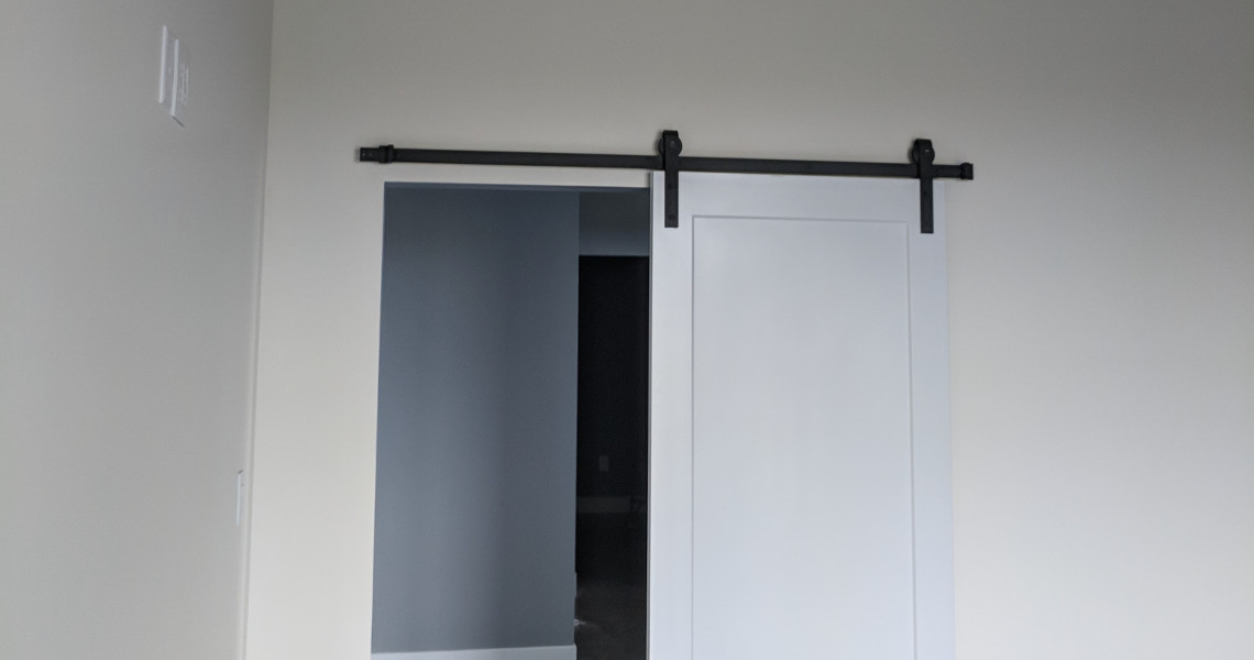 A shot of the sliding barn door inside of a metal barndominium designed and built by Worldwide Steel Buildings.