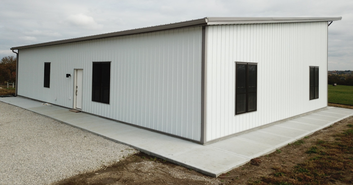 A close up shot of a metal barndominium designed and built by Worldwide Steel Buildings featuring a single slope roof.