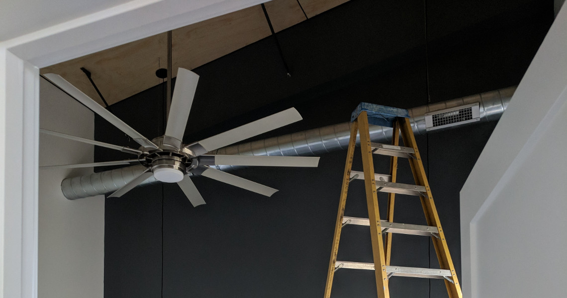 A ceiling fan with a step ladder next to it