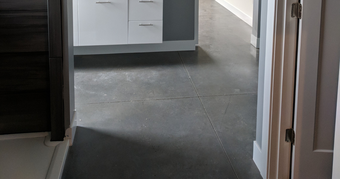 The dark gray tile flooring inside of a metal barndominium designed and built by Worldwide Steel Buildings.