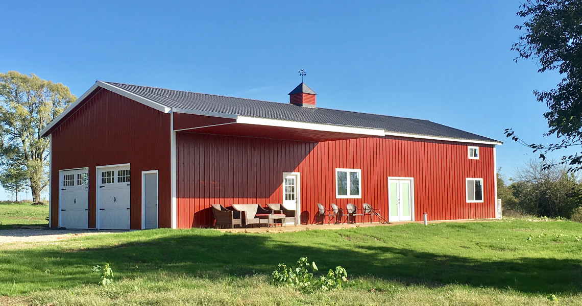 Side view of red barndominium steel building