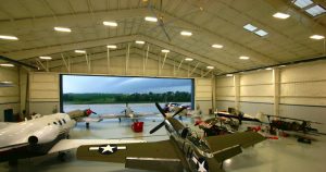 A classic airplane hangar from Worldwide Steel Buildings, interior with large open door.