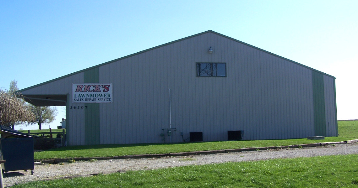 A large, gray metal building with a sign that reads 