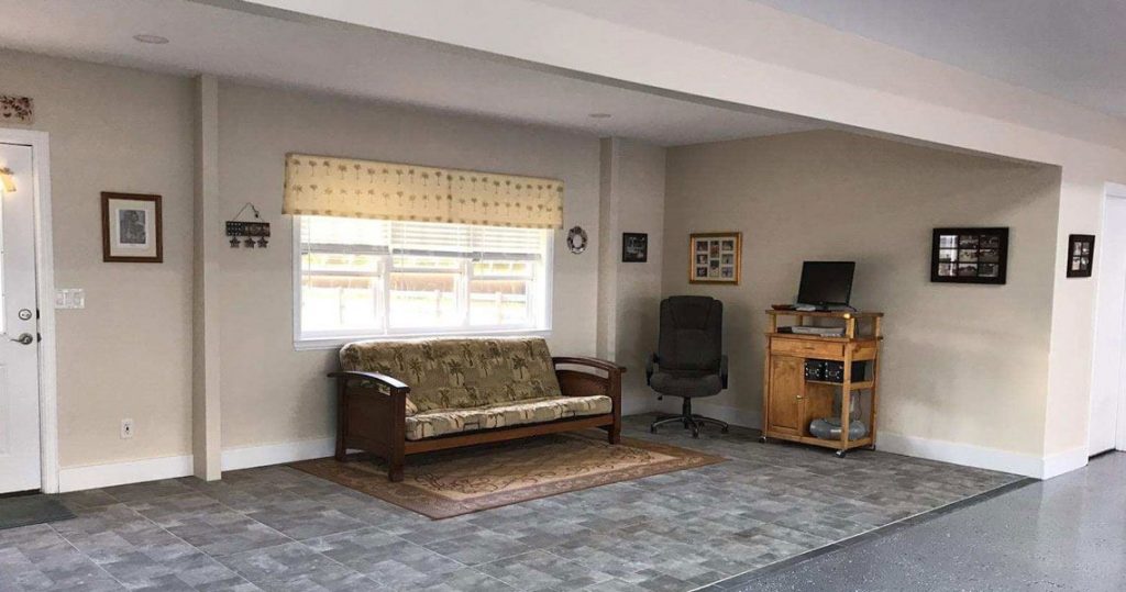 Living area in an airplane hangar with couch and office chair.