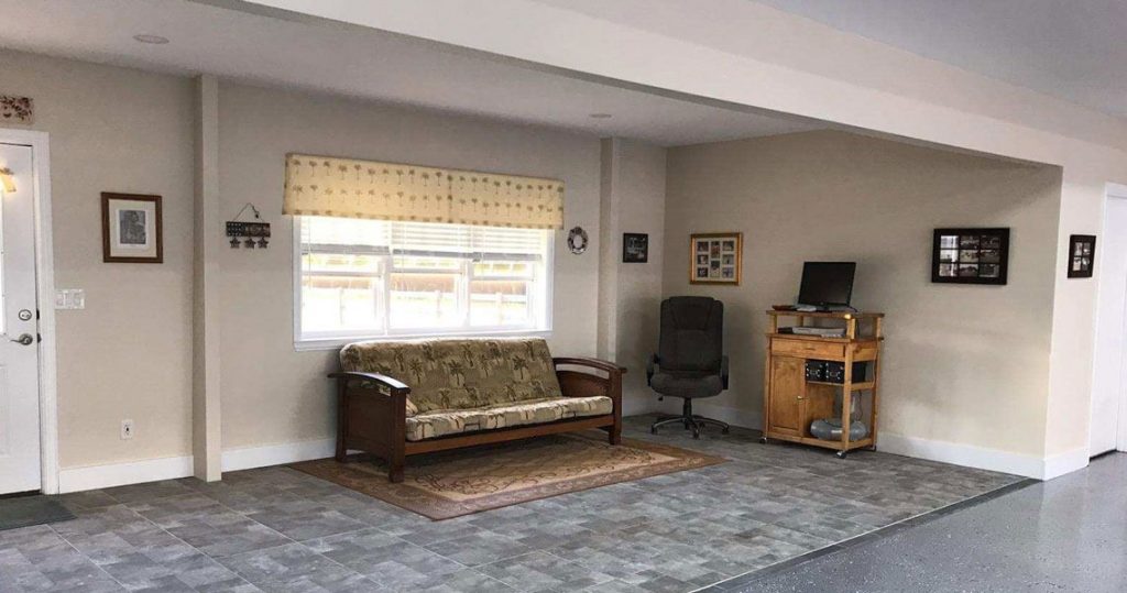 Living area in an airplane hangar with couch and office chair.
