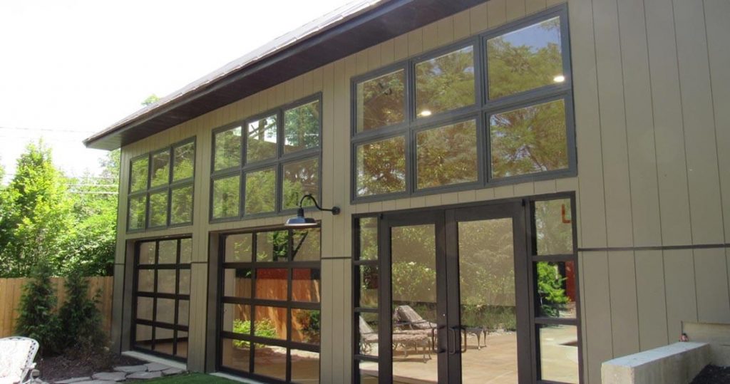 Exterior of tall, metal garage with two garage doors.