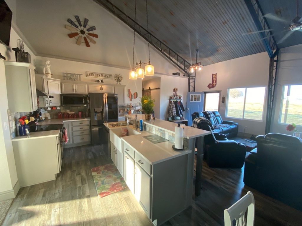 The interior of a residential metal building with a metal roof and beige wall color