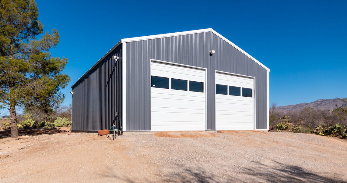 A gray, outdoor, steel workshop built in Vail, AZ by Worldwide Steel Buildings.