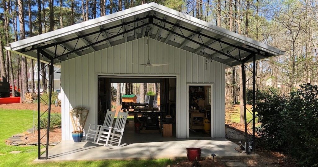 Exterior of small, white garage building.
