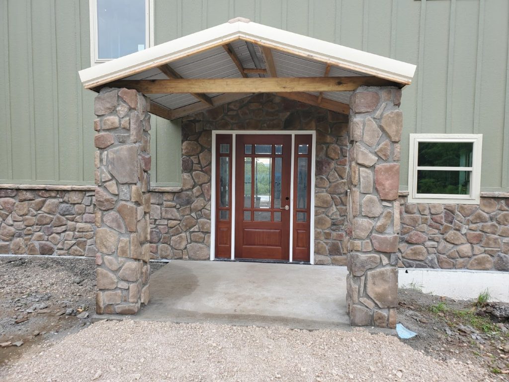 Front door of metal building home.
