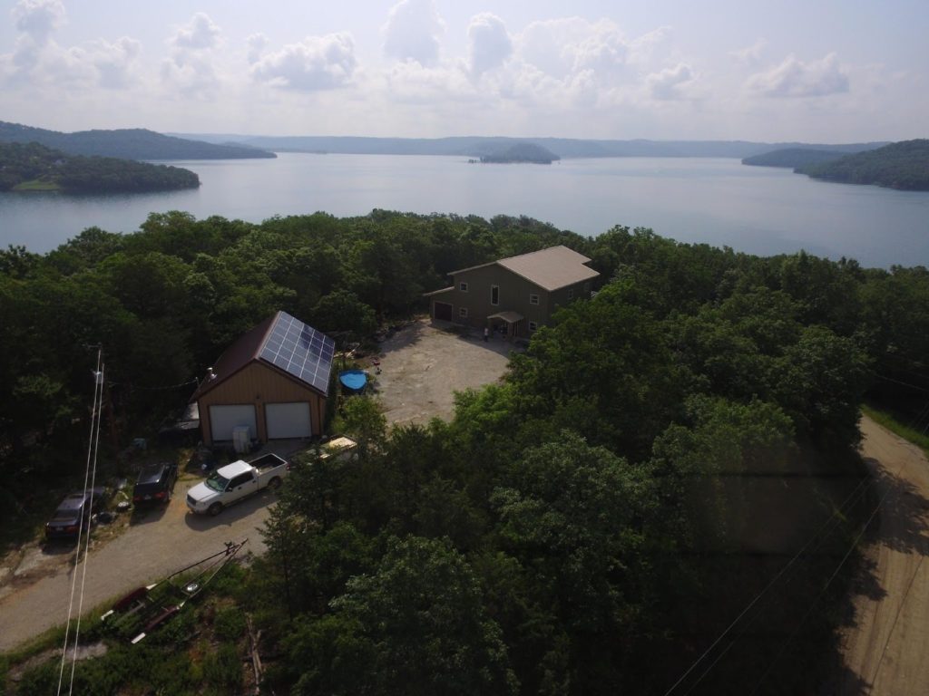 Steel Garage and Home with Solar Panels by a Lake