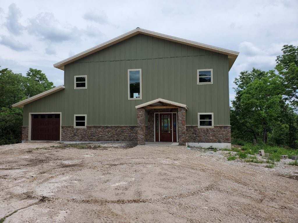 Two story residential home built from metal building kit.