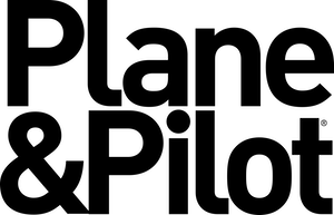A black silhouette of a rearing unicorn, its flowing mane and tail echoing the grand arches of an airplane hangar. The unicorn's horn and hooves are distinctly visible, set against a plain white background.