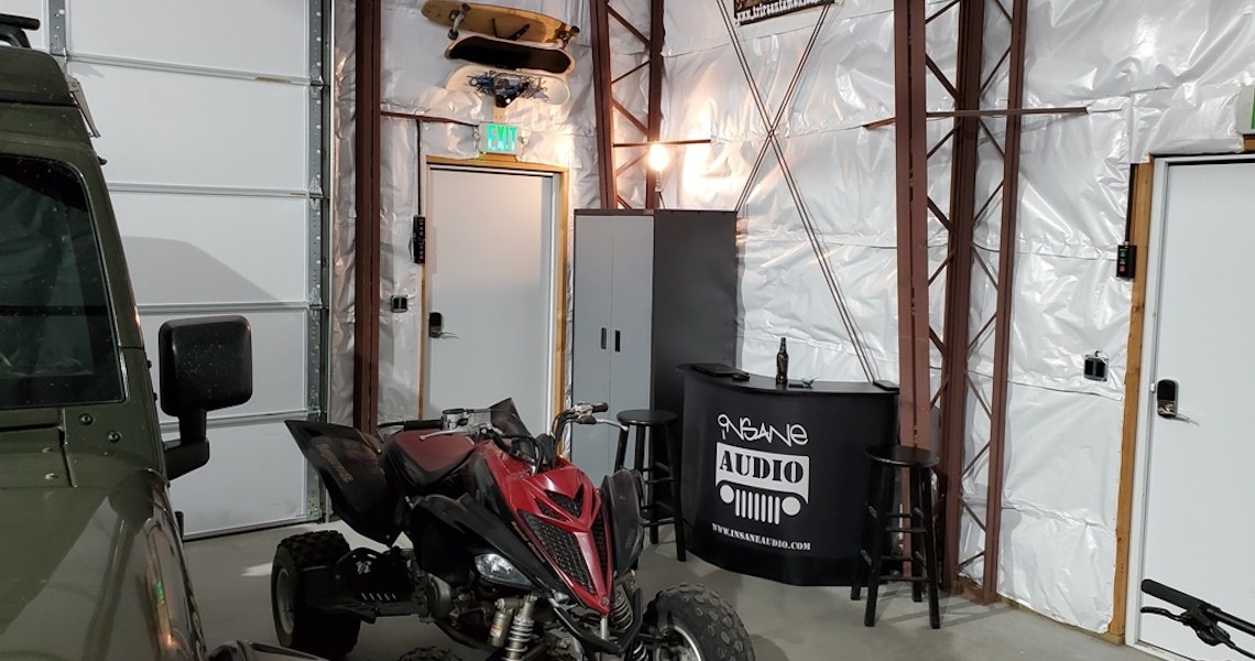 A California garage interior features a red ATV near a black counter labeled 