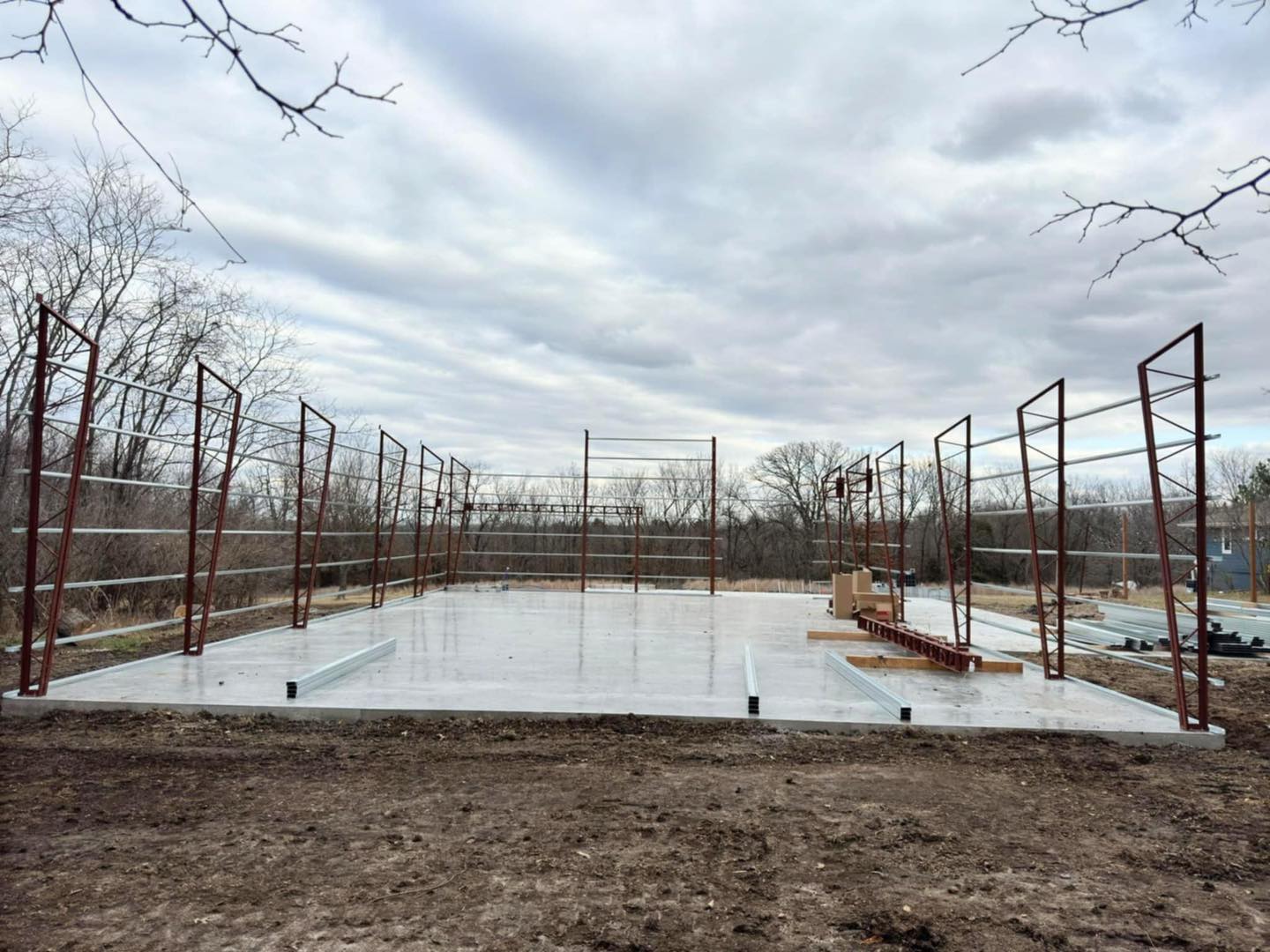 Construction site with concrete foundation and steel framework for future Litchford Garage.