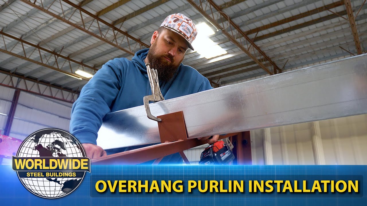 Man in blue hoodie installs overhang purlin on metal building; text: "WORLDWIDE STEEL BUILDINGS.
