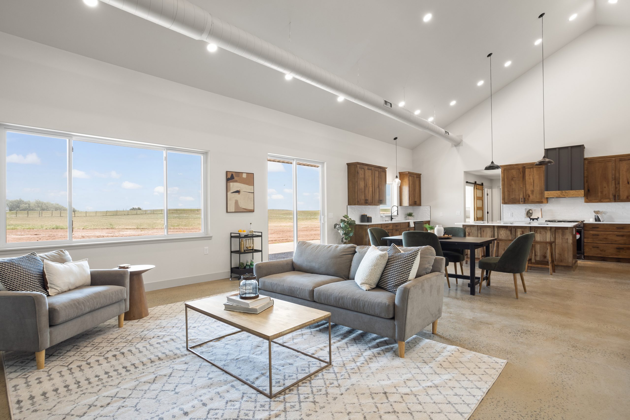 Living room and a kitchen with cabinets in a barndominium in Cheyenne, Wyoming