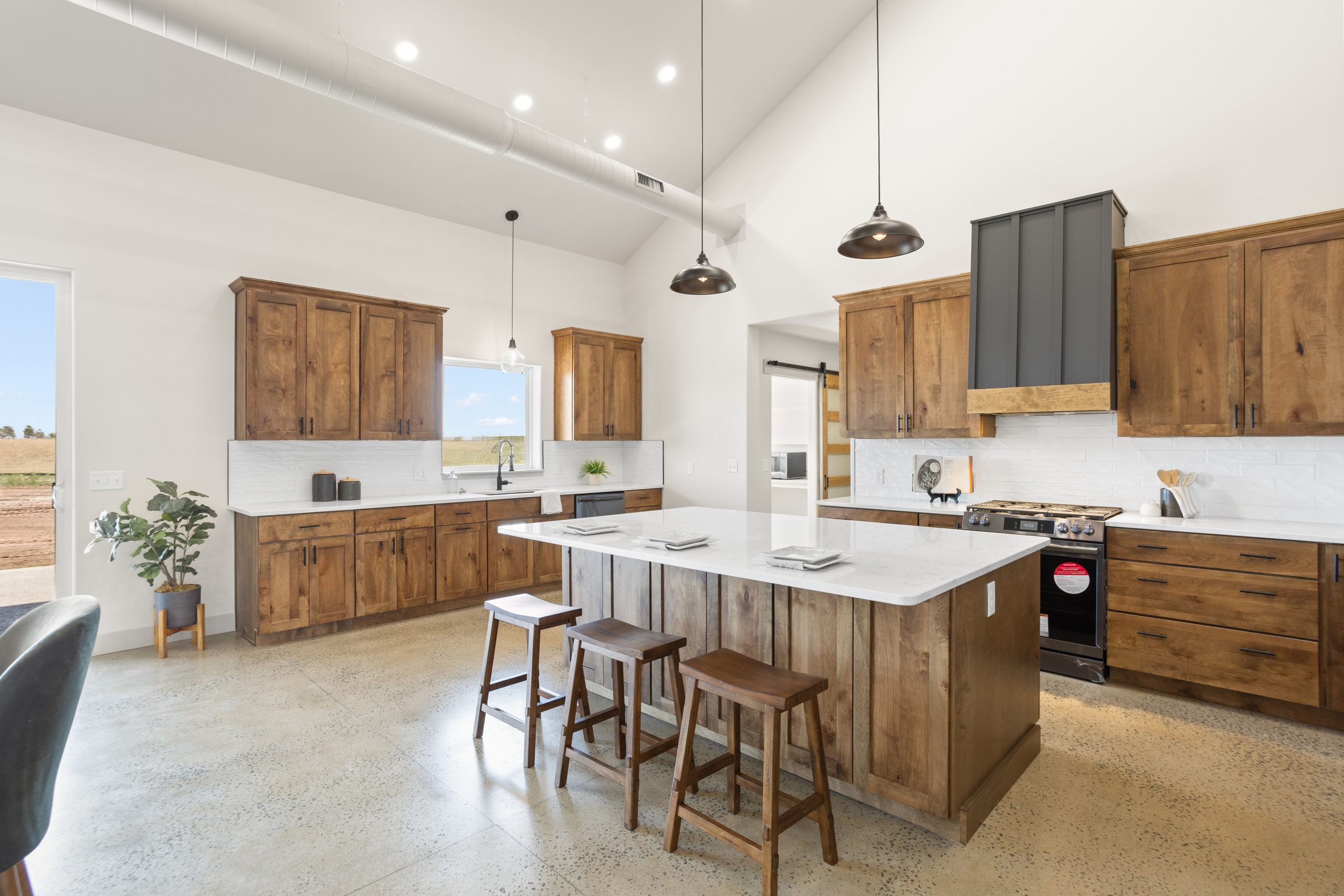 Kitchen island and cabinetry in the kitchen inside a barndominium in Cheyenne, Wyoming