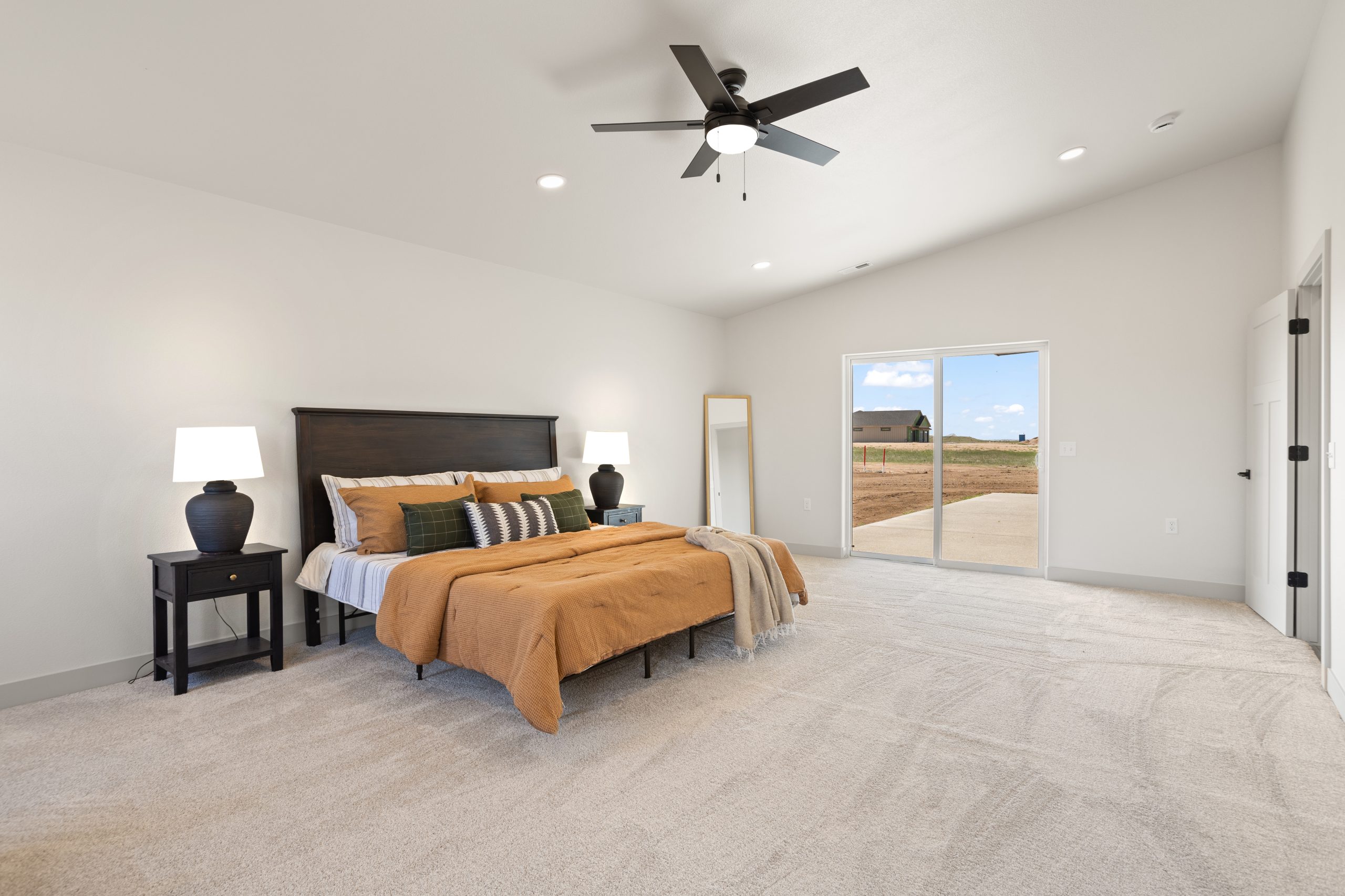 Furnished bedroom with a bed and nightstand inside a barndominium in Cheyenne, Wyoming