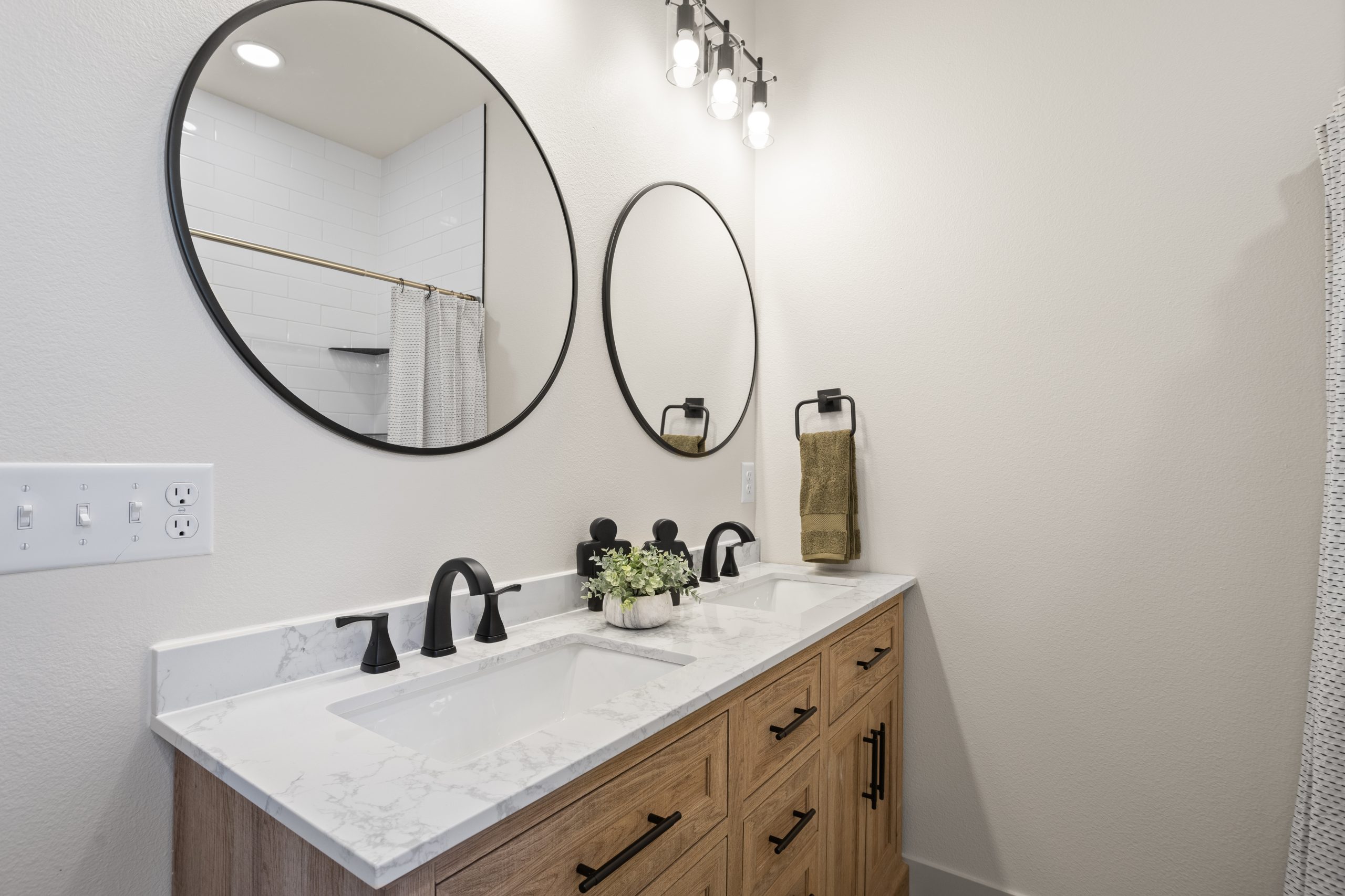 Bathroom sink with mirrors inside a barndominium in Cheyenne, Wyoming