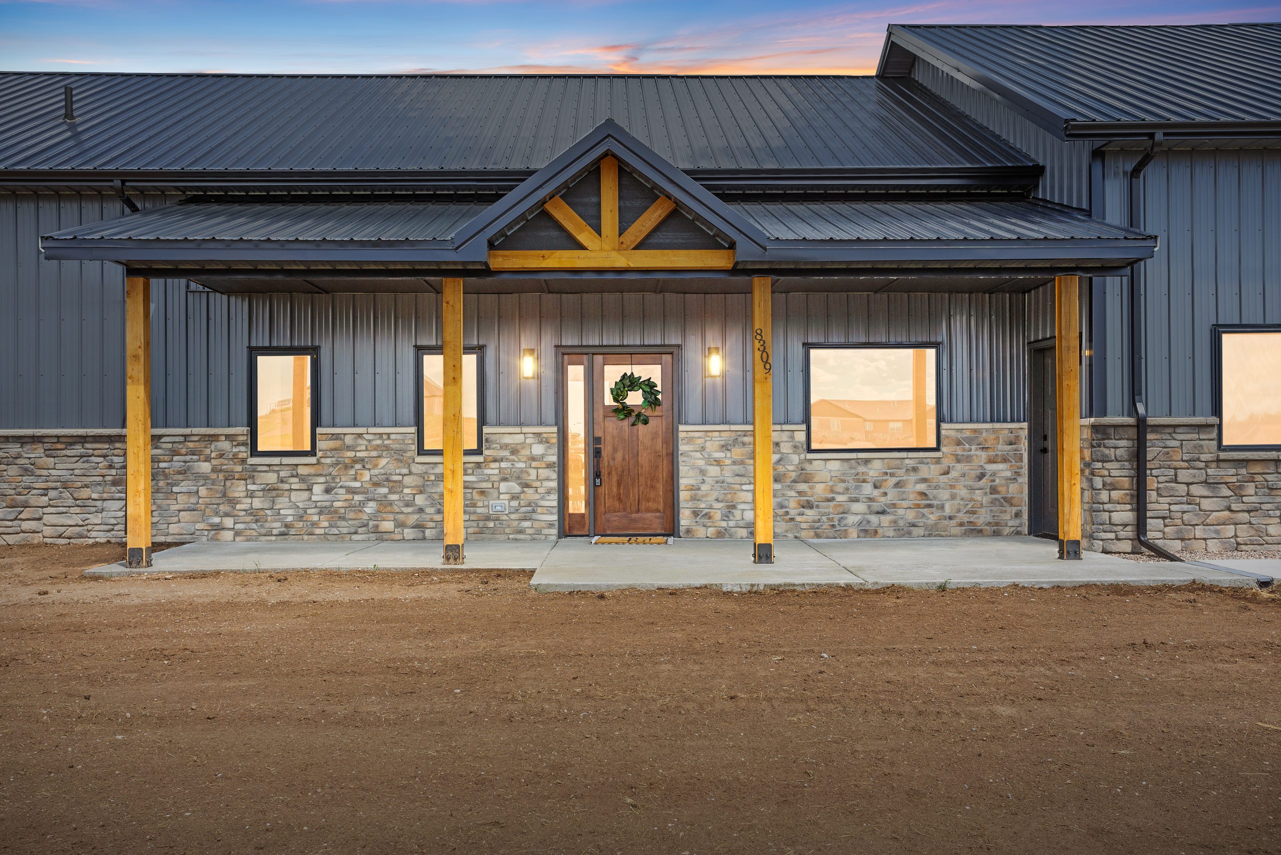 60x34 black gable barndominium exterior closeup with a covered porch entryway in Cheyenne, Wyoming