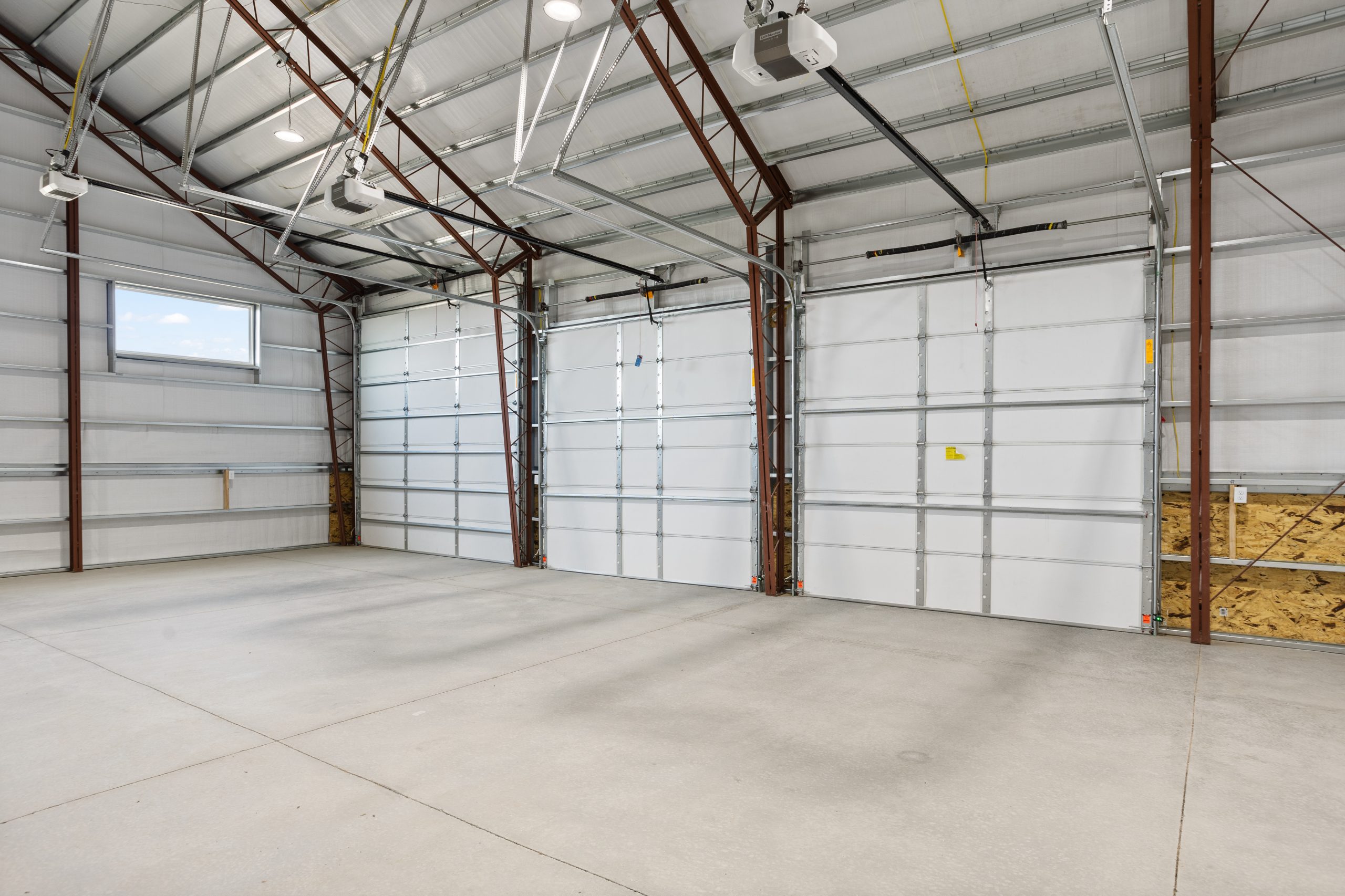 White garage interior with doors in a 60x34 barndominium in Cheyenne, Wyoming