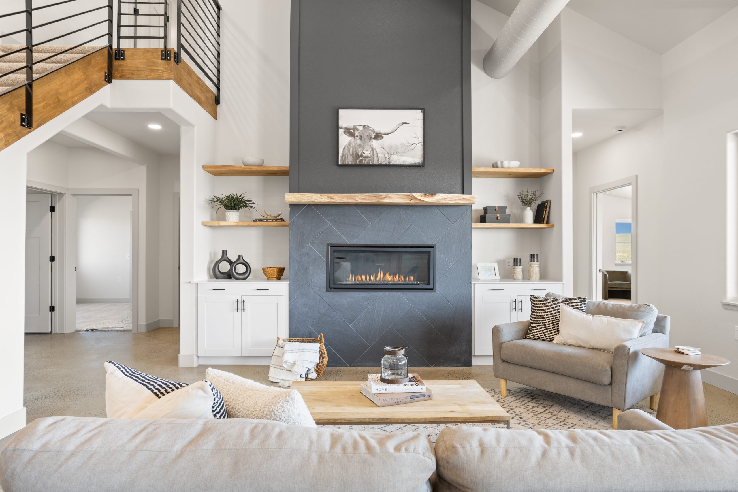Living room with sitting furniture and a fireplace inside a barndominium in Cheyenne, Wyoming