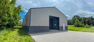 40x60 ash gray gable garage and shop with charcoal trim and wainscot, open overhead door bay and entry door in Raymore, MO.